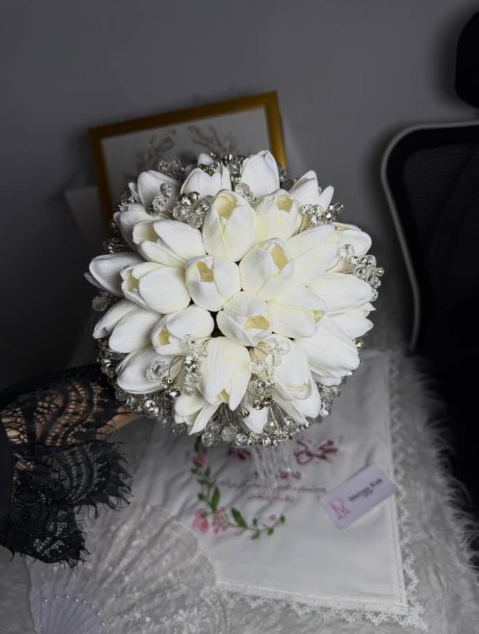 White bridal bouquet with keepsake details